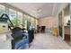 Bright sunroom with tile floors, lots of windows, and a ceiling fan to keep cool at 10668 Sw 85Th Ter, Ocala, FL 34481