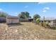 Large backyard featuring a shed, covered area, and a well-maintained lawn, perfect for relaxing outdoors at 1114 Hickory Rd, Ocala, FL 34472