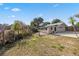 Backyard with a utility shed and garden, featuring a partially fenced in area at 1114 Hickory Rd, Ocala, FL 34472