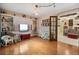 Spacious bedroom with hardwood floors and stylish glass paneled door at 1114 Hickory Rd, Ocala, FL 34472