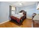 Comfortable bedroom featuring hardwood floors and a large window at 1114 Hickory Rd, Ocala, FL 34472