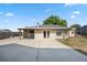 Exterior of the home featuring a covered patio, concrete pad, and a well-maintained lawn at 1114 Hickory Rd, Ocala, FL 34472