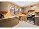 Cozy kitchen showcasing stainless steel appliances, functional cabinets, and tile flooring at 1114 Hickory Rd, Ocala, FL 34472