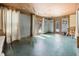 Large living area with turquoise flooring, curtain dividers and multiple glass doors at 1114 Hickory Rd, Ocala, FL 34472