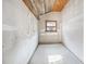 Small unfinished room shows drywall, plywood ceiling, concrete floor and natural light at 1114 Hickory Rd, Ocala, FL 34472