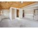 Unfinished room shows drywall, plywood ceiling, concrete floor and natural light at 1114 Hickory Rd, Ocala, FL 34472