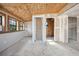 Unfinished room shows drywall, plywood ceiling, concrete floor and natural light at 1114 Hickory Rd, Ocala, FL 34472