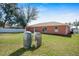 Spacious backyard featuring a lush lawn, privacy fence, and functional equipment, ideal for outdoor enjoyment at 13425 Sw 106Th Pl, Dunnellon, FL 34432