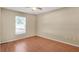 Well-lit bedroom boasts a window for natural light, wood floors and ample space for customization at 13425 Sw 106Th Pl, Dunnellon, FL 34432