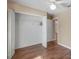 This bedroom features wood floors and a closet with plenty of room for storage and organization at 13425 Sw 106Th Pl, Dunnellon, FL 34432