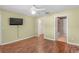 Spacious bedroom features wood floors, neutral walls, a ceiling fan and easy access to a bathroom at 13425 Sw 106Th Pl, Dunnellon, FL 34432