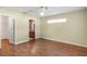 Large bedroom with wood laminate flooring, a ceiling fan and easy access to a bathroom with beautiful wallpaper at 13425 Sw 106Th Pl, Dunnellon, FL 34432