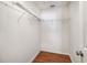 Walk-in closet with wood floors and ample shelving to store clothes and personal belongings at 13425 Sw 106Th Pl, Dunnellon, FL 34432