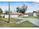 Well-maintained home featuring a long driveway, two-car garage, lush lawn, and fenced yard at 13425 Sw 106Th Pl, Dunnellon, FL 34432