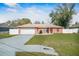 Charming house with a spacious front yard, a large driveway, and a two-car garage at 13425 Sw 106Th Pl, Dunnellon, FL 34432