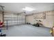 Spacious two-car garage with ample storage space and potential for a workshop area at 13425 Sw 106Th Pl, Dunnellon, FL 34432