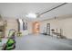 Spacious garage with sealed floors, plenty of storage, a ladder and room for a workout station at 13425 Sw 106Th Pl, Dunnellon, FL 34432