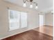 Living room features wood floor and large window providing natural light at 13425 Sw 106Th Pl, Dunnellon, FL 34432