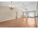 Spacious living room features vaulted ceiling, wood floors and elegant chandelier at 13425 Sw 106Th Pl, Dunnellon, FL 34432