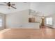 Spacious living room boasting hardwood floors, a vaulted ceiling, and an open layout into the kitchen area at 13425 Sw 106Th Pl, Dunnellon, FL 34432