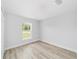 Bright bedroom with wood-look floors and large window at 13505 Sw 112 Pl, Dunnellon, FL 34432