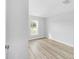 Bedroom featuring wood-look floors, natural light, and neutral paint at 13505 Sw 112 Pl, Dunnellon, FL 34432