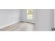 Bedroom featuring wood-look floors and a large window at 13505 Sw 112 Pl, Dunnellon, FL 34432