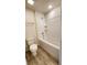Clean, white bathroom features a bathtub with a shower head and a white toilet at 15407 Sw 59Th Avenue Rd, Ocala, FL 34473