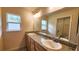 Modern bathroom features double sinks with granite countertops, vanity, and bright vanity lighting at 15407 Sw 59Th Avenue Rd, Ocala, FL 34473