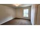 Comfortable bedroom featuring carpet floors and a window providing natural light at 15407 Sw 59Th Avenue Rd, Ocala, FL 34473