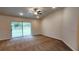 Spacious bedroom with carpet floors and a sliding glass door leading to the backyard at 15407 Sw 59Th Avenue Rd, Ocala, FL 34473