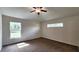 This bedroom has two windows that allows the natural light to brighten the room and brown carpet at 15407 Sw 59Th Avenue Rd, Ocala, FL 34473