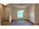 Open dining room featuring neutral walls, carpet floors, and a modern chandelier at 15407 Sw 59Th Avenue Rd, Ocala, FL 34473