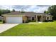 Charming single-story home with a well-manicured lawn and an attached two-car garage at 15407 Sw 59Th Avenue Rd, Ocala, FL 34473