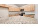 Close-up of kitchen with granite countertops, wooden cabinets, and stainless steel appliances at 15407 Sw 59Th Avenue Rd, Ocala, FL 34473