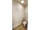 Cozy powder room features a toilet and laminate flooring at 15407 Sw 59Th Avenue Rd, Ocala, FL 34473