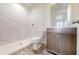 Modern bathroom with walk-in shower, marble-look tile, contemporary vanity, and neutral color palette at 1598 Sw 152Nd Ct, Ocala, FL 34481