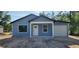Charming single-story home with blue siding and attached one car garage at 1598 Sw 152Nd Ct, Ocala, FL 34481