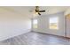 Spacious bedroom featuring wood-look floors, two windows, and a ceiling fan at 1610 Sw 152Nd Ct, Ocala, FL 34481