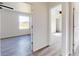 Hallway view showcasing wood-look floors and access to sunlit bedrooms and living spaces at 1610 Sw 152Nd Ct, Ocala, FL 34481