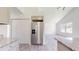 Kitchen view with stainless steel refrigerator, granite counters, and white cabinets at 1610 Sw 152Nd Ct, Ocala, FL 34481