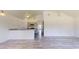 Open-concept living space with modern gray wood floors and vaulted ceilings at 1610 Sw 152Nd Ct, Ocala, FL 34481