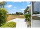 Manicured backyard with a concrete patio, view of the golf course, and lush landscaping at 17505 Se 100Th Ct, Summerfield, FL 34491