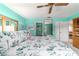 Bedroom featuring calming light blue walls, ceiling fan, and view into the ensuite bathroom at 17505 Se 100Th Ct, Summerfield, FL 34491