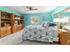 Comfortable bedroom featuring a large window and a built-in shelving unit, perfect for storage and display at 17505 Se 100Th Ct, Summerfield, FL 34491