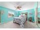 Inviting bedroom features calming blue walls, neutral carpet, and a window that brings in natural light at 17505 Se 100Th Ct, Summerfield, FL 34491