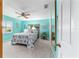 Bright bedroom featuring blue walls, ceiling fan, and large window with white shutters for ample natural light at 17505 Se 100Th Ct, Summerfield, FL 34491