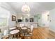 Dining area with glass table, plush chairs, and adjacent kitchen at 17505 Se 100Th Ct, Summerfield, FL 34491