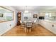 Bright dining area features wood floors, chandelier, and large mirror at 17505 Se 100Th Ct, Summerfield, FL 34491