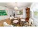 Dining area with glass table, clock, and view to front yard at 17505 Se 100Th Ct, Summerfield, FL 34491